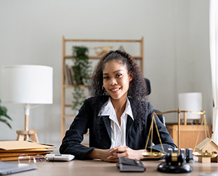 portrait smiling female lawyer sitting at workplac JL2L95D