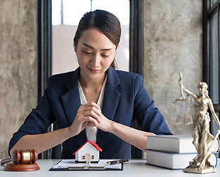 real estate concept businesswoman holding a house L5LGMDP